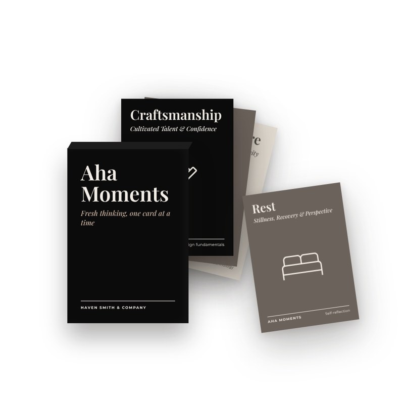 Black Aha Moments tuck box with cards fanned out.