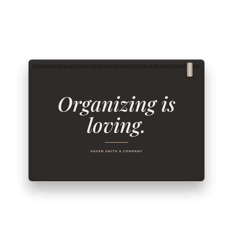 A charcoal zip pouch printed with Organizing is loving and Haven Smith & Company.